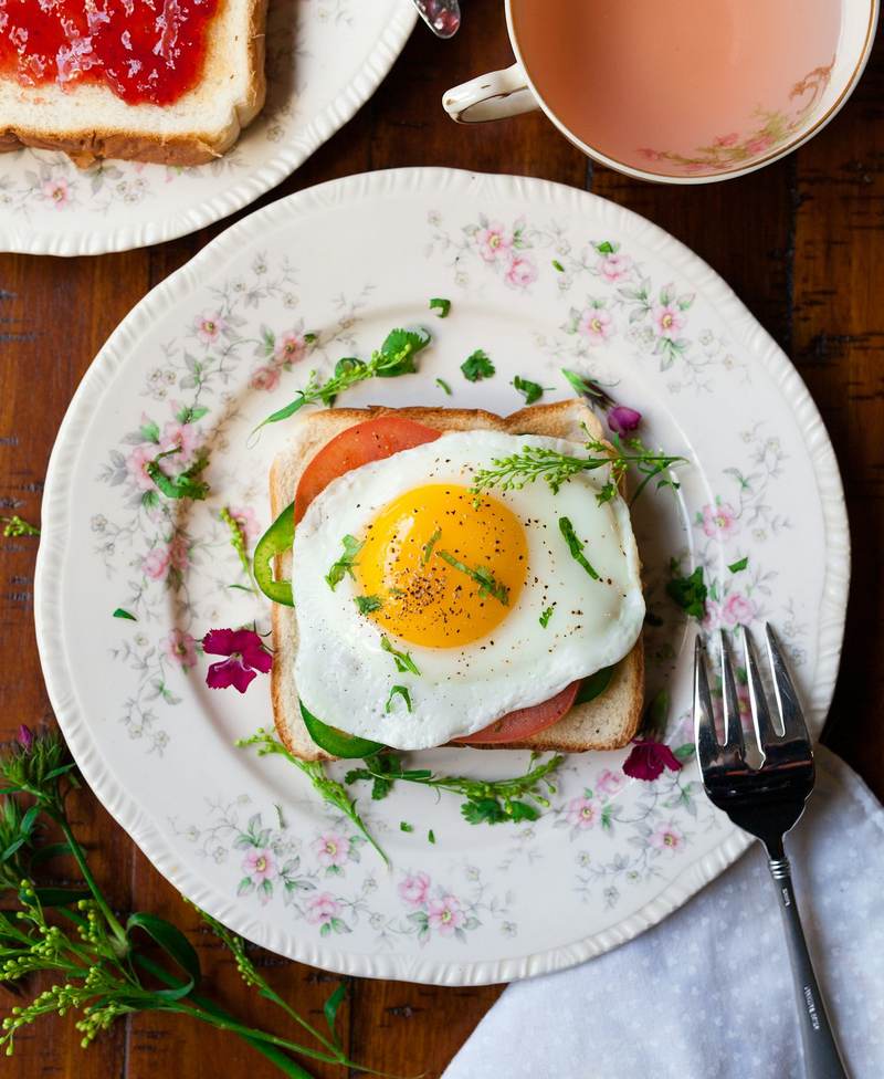 A fried egg on toast on a floral plate